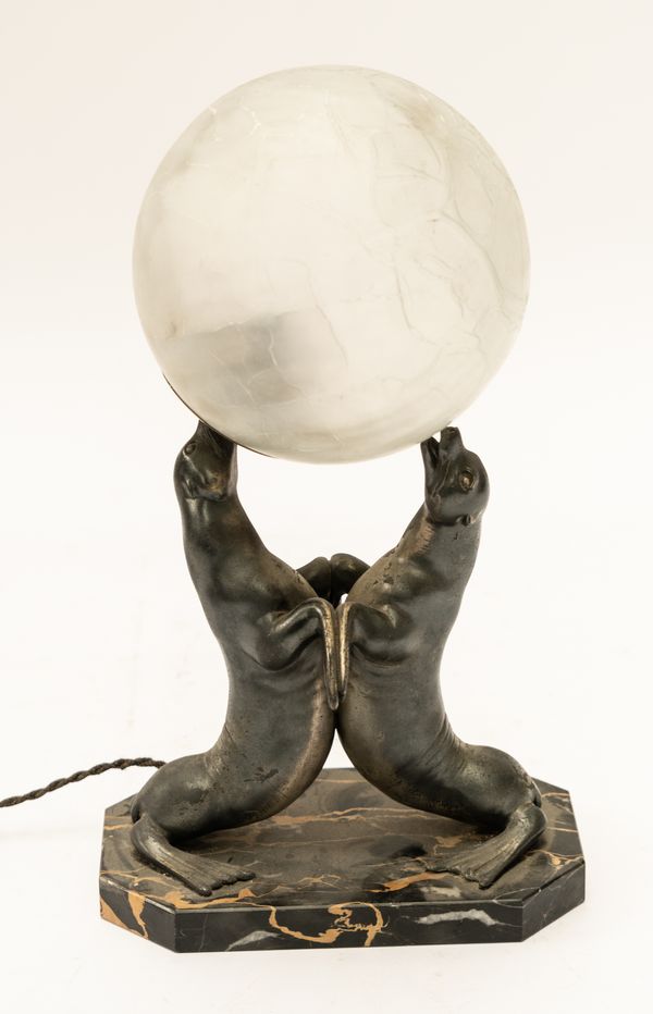 LOUIS ALBERT CARVIN: AN ART DECO SILVERED SPELTER TABLE LAMP MODELLED A PAIR OF PERFORMING SEALS