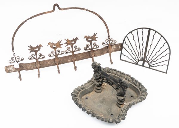 A CAST IRON BOOT SCRAPER, SET OF COAT HOOKS AND A PIECE OF DECORATIVE IRONWORK (3)