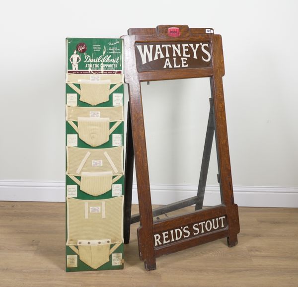 A WATNEY’S ALE A-BOARD DISPLAY SIGN AND AN ATHLETIC CLOTHING SIGN (2)