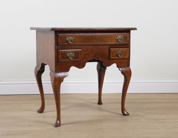 A GEORGE II INLAID FIGURED WALNUT THREE DRAWER LOW BOY