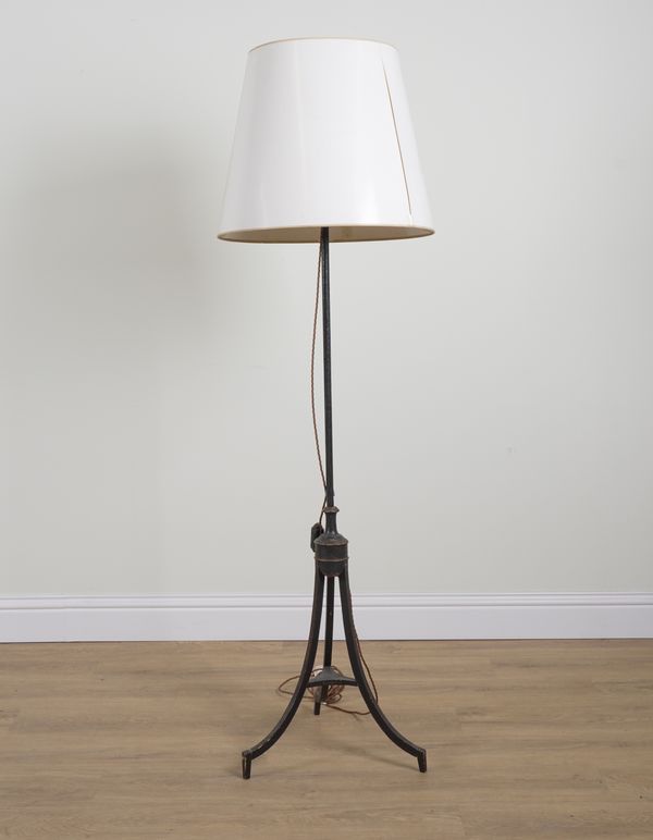 A REGENCY STYLE JAPANNED METAL AND GILT-DECORAGED TRIPOD FLOOR STANDING LIGHT