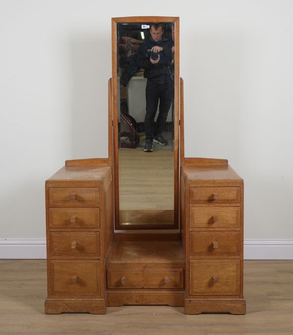 COTSWOLDS SCHOOL DESIGN; A 20TH CENTURY OAK TWIN PEDESTAL DRESSING TABLE