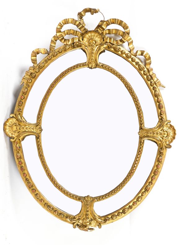 A 19TH CENTURY FRENCH GILT FRAMED OVAL MARGINAL WALL MIRROR