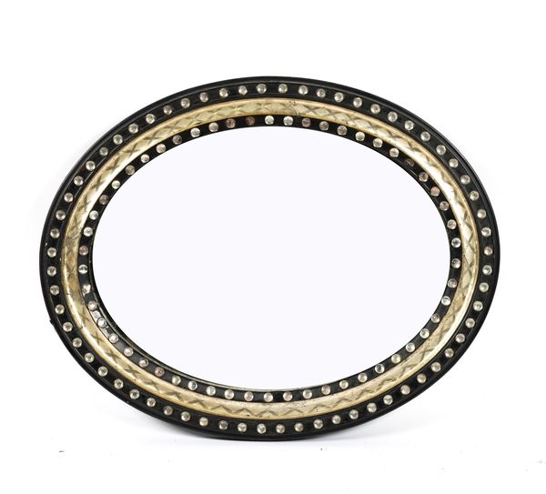 A 19TH CENTURY IRISH EBONISED OVAL MIRROR