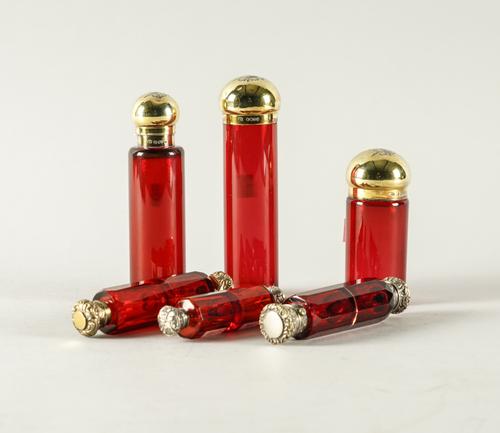 THREE SILVER GILT MOUNTED VICTORIAN CRANBERRY COLOURED GLASS TOILET BOTTLES AND THREE FURTHER ITEMS (6)