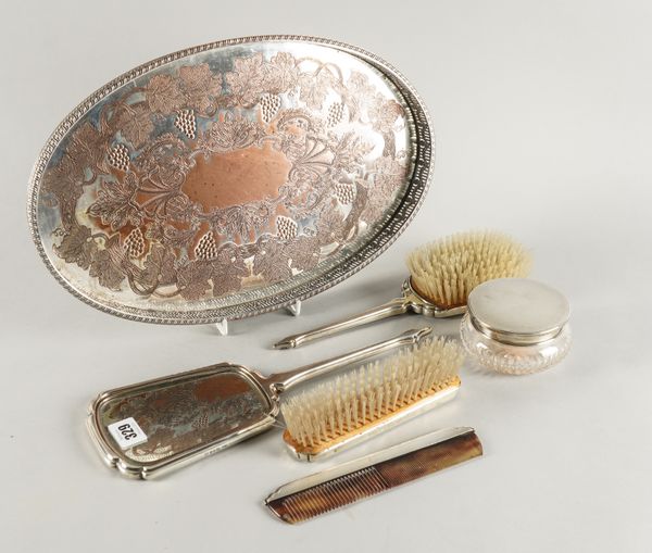 A SILVER MOUNTED FOUR PIECE DRESSING SET, A POWDER BOWL AND A PLATED TRAY (6)