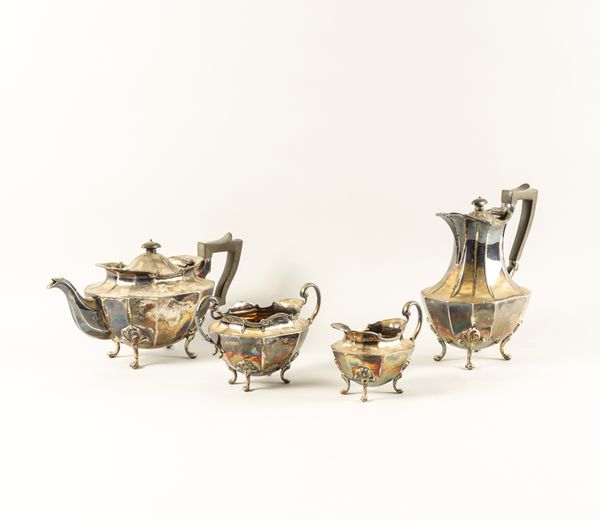 A SILVER THREE PIECE TEA SET AND A SIMILAR HOT WATER JUG (4)