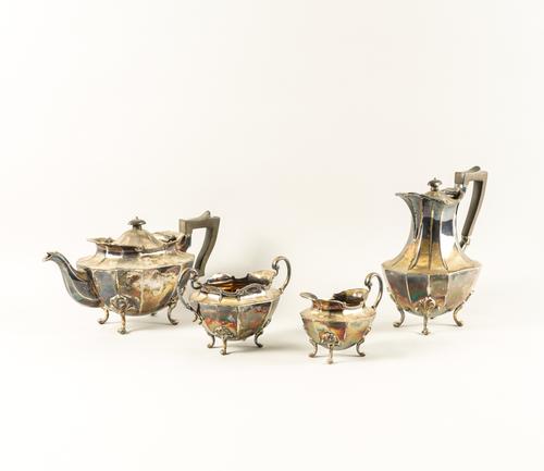 A SILVER THREE PIECE TEA SET AND A SIMILAR HOT WATER JUG (4)