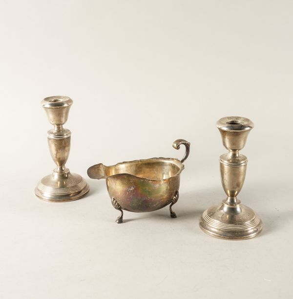 A SILVER SAUCEBOAT AND A PAIR OF SILVER CANDLESTICKS (2)