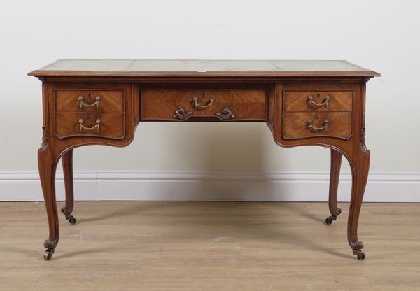 A LOUIS XV STYLE WALNUT FIVE DRAWER WRITING TABLE