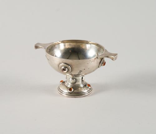 A SILVER AND ORANGE PASTE SET TWIN HANDLED PEDESTAL BOWL