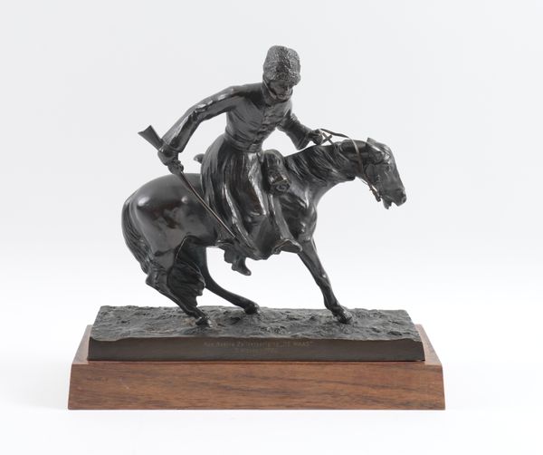 SIGNED TYPAGSNE: A RUSSIAN EQUESTRIAN BRONZE OF A COSSACK