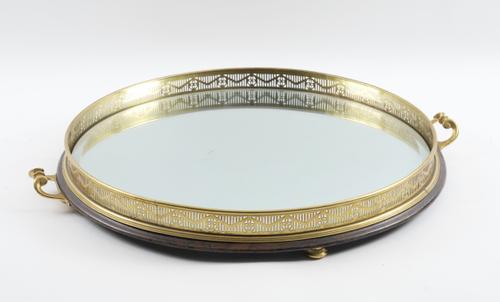 A GILT-METAL AND MIRRORED GLASS CIRCULAR TRAY