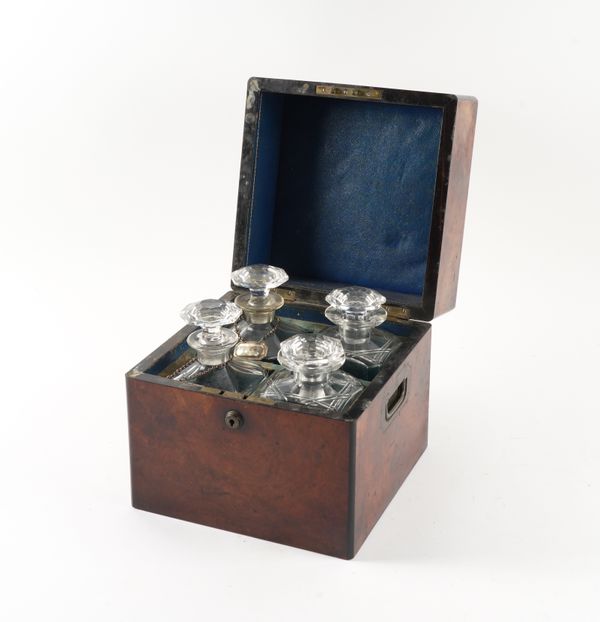 A 19TH CENTURY FIGURED WALNUT FOUR BOTTLE DECANTER BOX