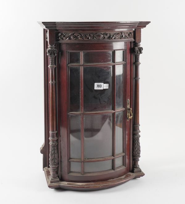 A LATE 19TH CENTURY CARVED MAHOGANY BOWFRONT HANGING DISPLAY CABINET