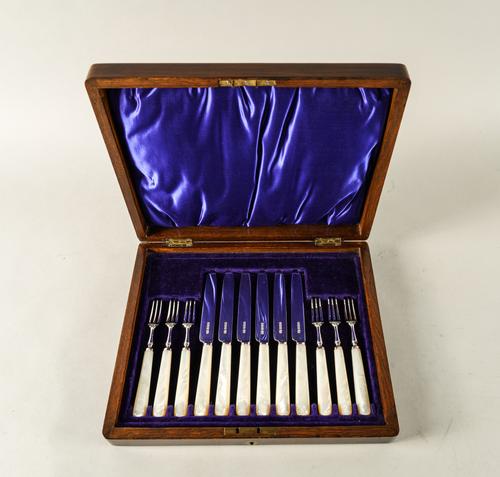 A SET OF SIX PAIRS OF DESSERT OR FRUIT KNIVES AND FORKS