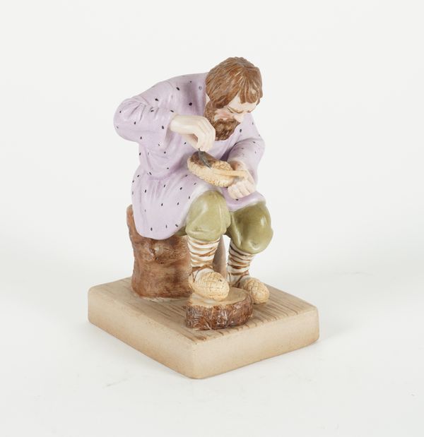 A RUSSIAN BISCUIT PORCELAIN FIGURE OF A LAPTI PLAYER