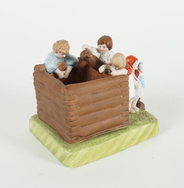 A RUSSIAN BISCUIT PORCELAIN FIGURE GROUP DEPICTING CHILDREN AT A WELL