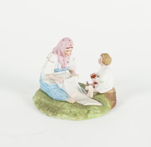 A RUSSIAN BISCUIT PORCELAIN FIGURE GROUP OF MOTHER AND CHILD