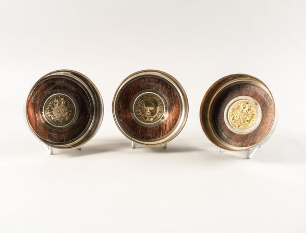 A SET OF THREE SILVER MOUNTED CIRCULAR BOTTLE CASTERS (3)