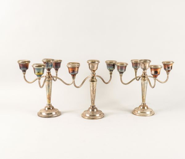 A GARNITURE OF THREE SILVER TABLE CANDELABRA (3)