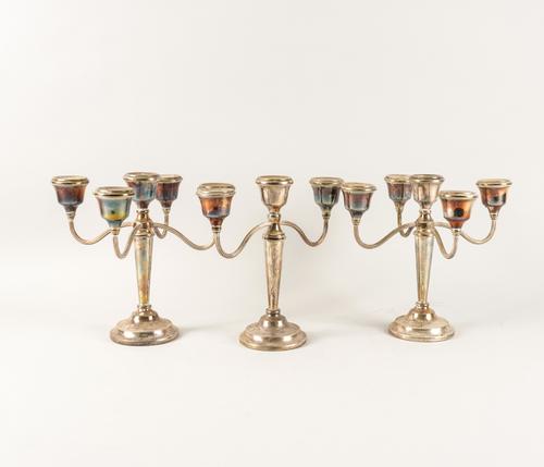 A GARNITURE OF THREE SILVER TABLE CANDELABRA (3)