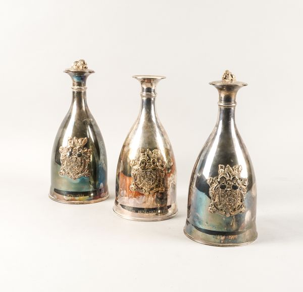 A SET OF THREE SILVER DECANTERS