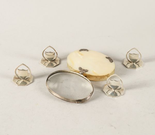 A SET OF FOUR SILVER PLACE NAME OR MENU STANDS AND A SILVER AND MOTHER-OF-PEARL OVAL MAGNIFYING GLASS (5)