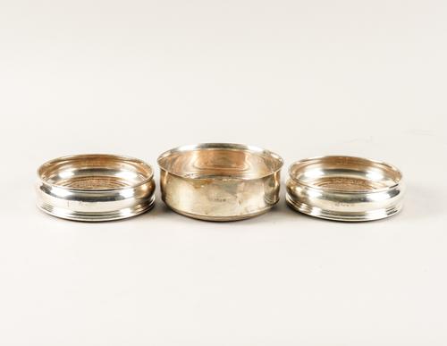 A SILVER MOUNTED BOTTLE COASTER AND A PAIR OF SILVER MOUNTED BOTTLE COASTERS (3)