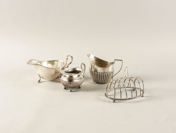 A SILVER SAUCEBOAT AND THREE FURTHER ITEMS (4)