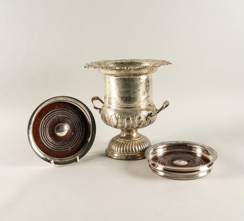 A PLATED TWIN HANDLED WINE COOLER AND A PAIR OF PLATED LARGE COASTERS