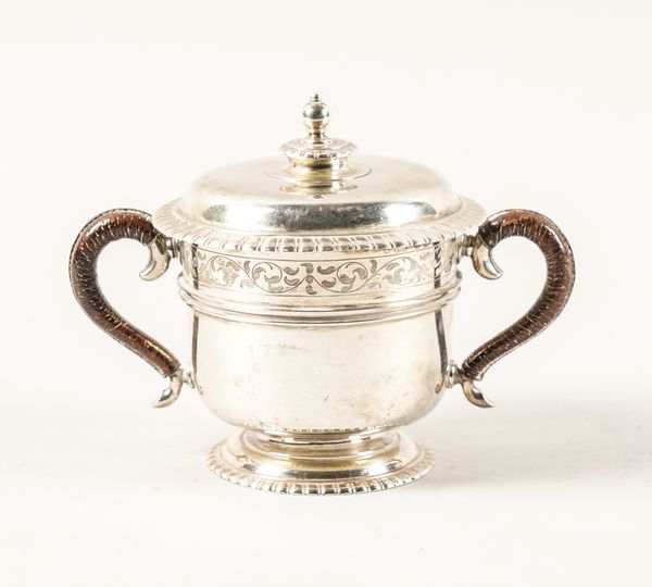 A SILVER TWIN HANDLED PORRINGER WITH COVER