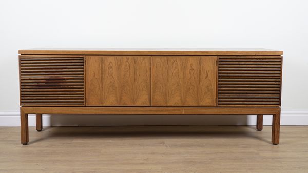 PROBABLY ARCHIE SHINE FOR HEALS FURNITURE; A MID 20TH CENTURY ROSEWOOD FOUR DOOR SIDEBOARD