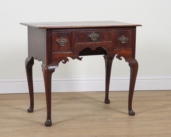 A GEORGE II OAK THREE DRAWER LOWBOY