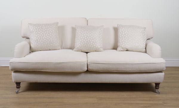 A MODERN CREAM UPHOLSTERED THREE SEAT SOFA