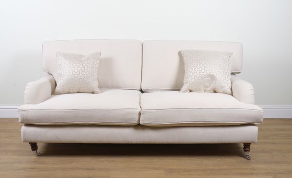 A MODERN CREAM UPHOLSTERED THREE SEAT SOFA