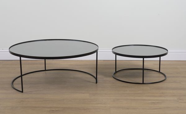 NOTRE MONDE; A GRADUATED PAIR OF EBONISED CIRCULAR OCCASIONAL TABLES (2)