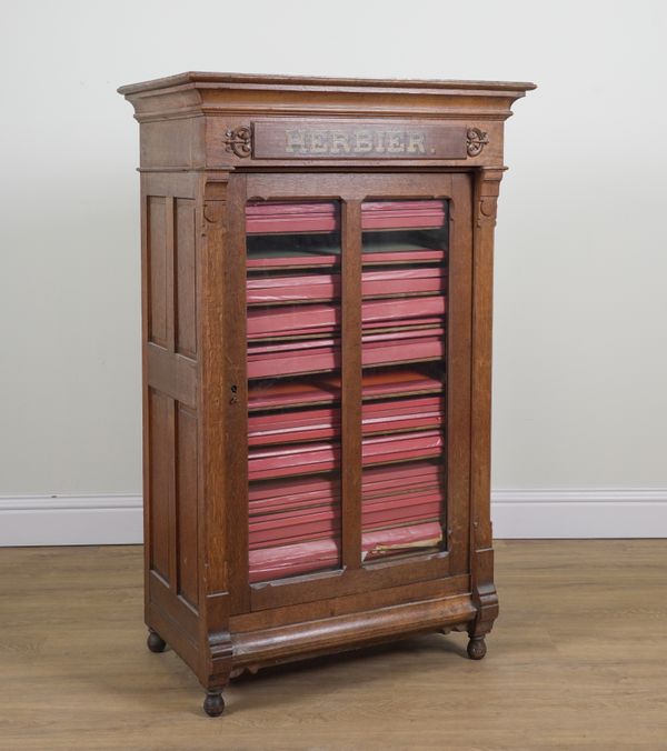 A 19TH CENTURY FRENCH OAK HERB CABINET