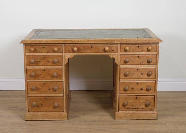 A VICTORIAN PINE ELEVEN DRAWER KNEEHOLE WRITING DESK