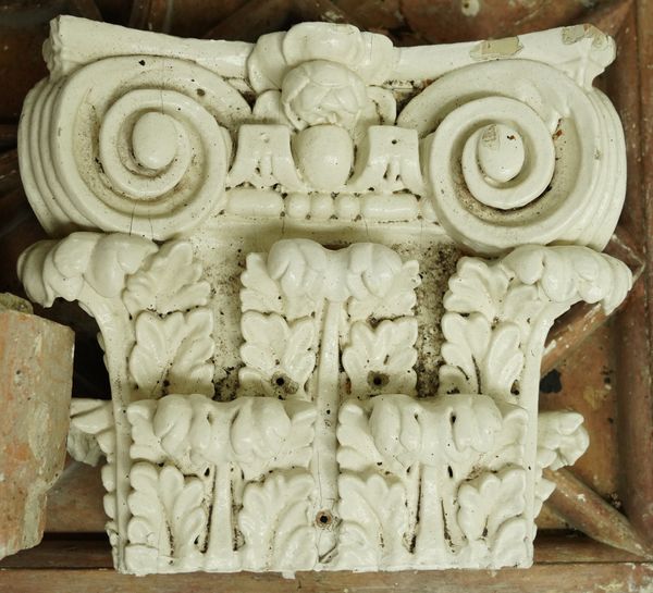 A GROUP OF MOULDED PLASTER ARCHITECTURAL PLAQUES AND ELEMENTS, TOGETHER WITH PAINTED WOOD CORINTHIAN CAPITALS (QTY)