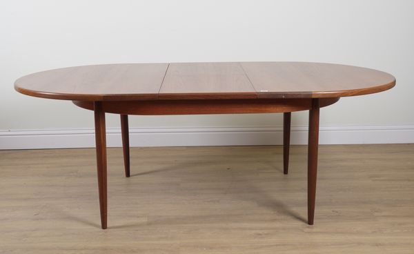 G-PLAN; A TEAK OVAL EXTENDING DINING TABLE