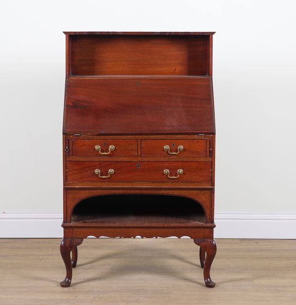 IN THE MANNER OF LIBERTY’S; A MAHOGANY BUREAU WITH INTEGRAL SHELF BACK