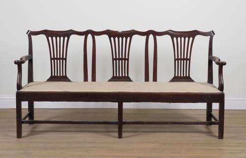 A GEORGE III OAK FRAMED TRIPLE CHAIR BACK OPEN ARM SOFA