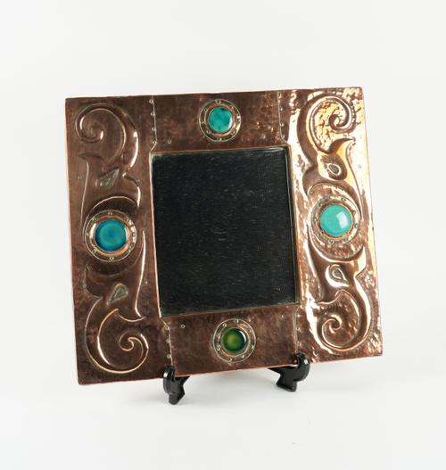 AN ART NOUVEAU COPPER AND ENAMEL MIRROR IN THE MANNER OF LIBERTY