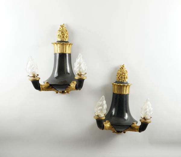 A PAIR OF REGENCY STYLE BLACK AND GILT TWIN BRANCH TORCH STYLE WALL LIGHTS (2)