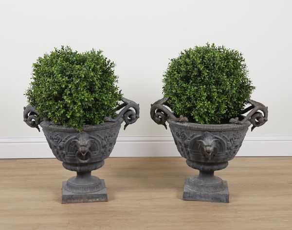 A PAIR OF PATINATED GARDEN URNS WITH LION MASK HANDLES (2)