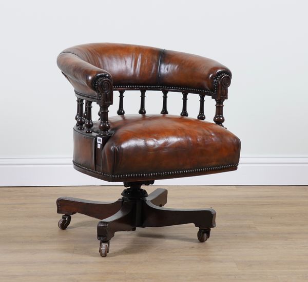 A VICTORIAN LEATHER UPHOLSTERED MAHOGANY REVOLVING DESK CHAIR