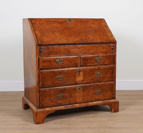 A GEORGE II WALNUT FOUR DRAWER BUREAU