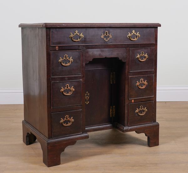 A GEORGE III MAHOGANY EIGHT DRAWER KNEEHOLE WRITING DESK