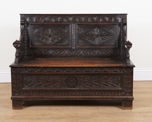 A VICTORIAN CARVED OAK BOX SEAT SETTLE